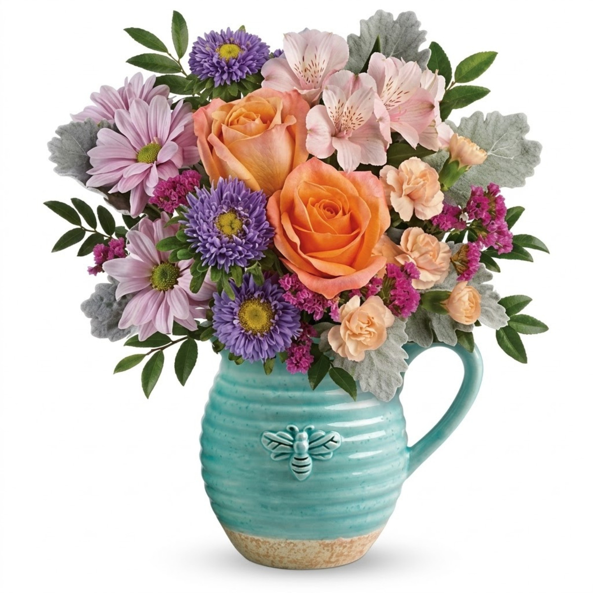 A vibrant floral arrangement featuring orange roses, pink alstroemeria, purple chrysanthemums, and peach carnations in a ribbed turquoise ceramic pitcher vase with a green bee accent.