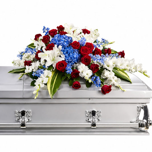 Red white and blue casket spray with roses lilies and hydrangea