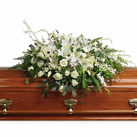White rose and lily casket spray with eucalyptus and curly willow