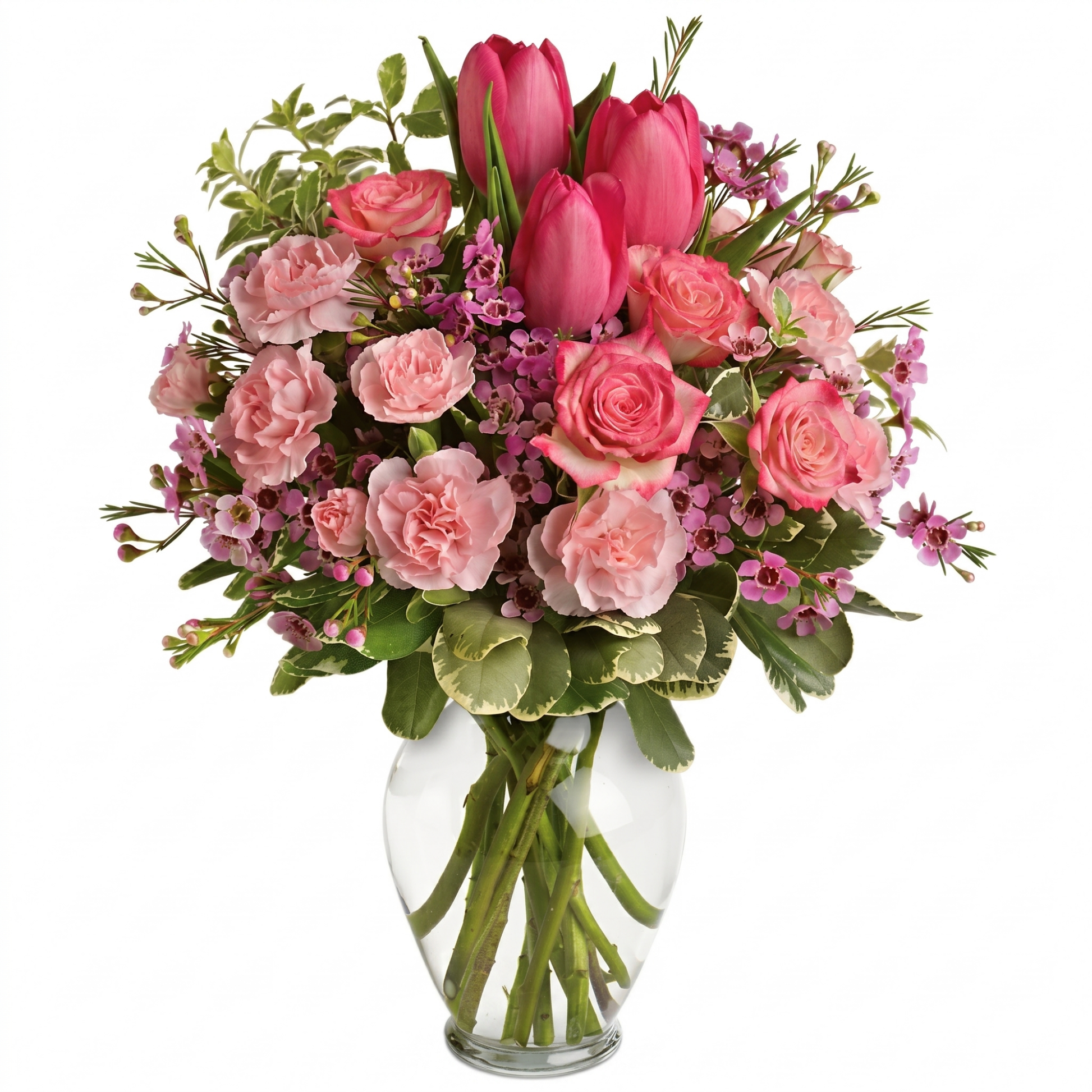 Full of love bouquet with pink tulips, spray roses, carnations and wax flowers in clear glass vase