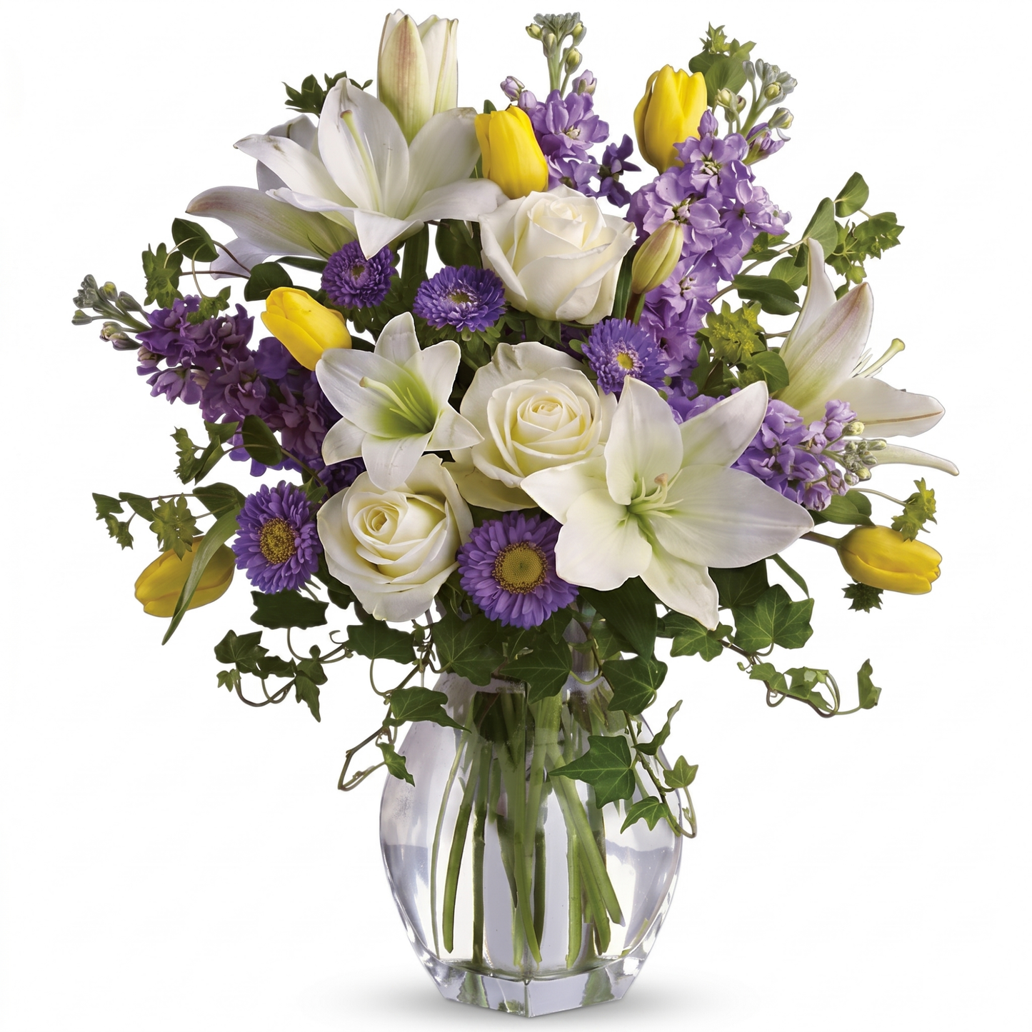 Spring waltz bouquet with white roses, asiatic lilies, purple asters, yellow tulips and lavender stock in clear glass vase