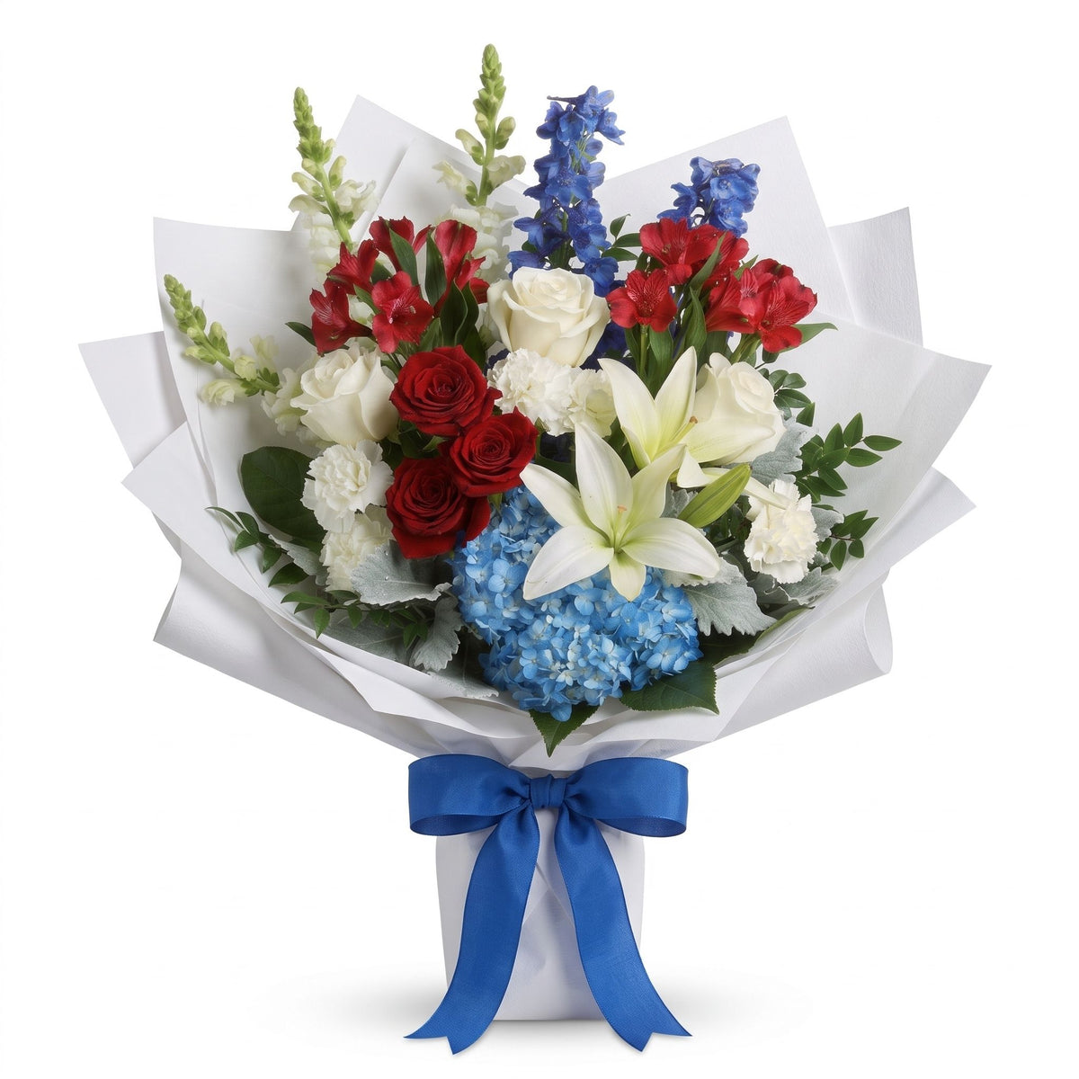 Liberty Bloom Bouquet with red and white roses, white lilies and blue hydrangea, wrapped in white paper with a blue ribbon, from Karen's Floral in Bolingbrook, IL